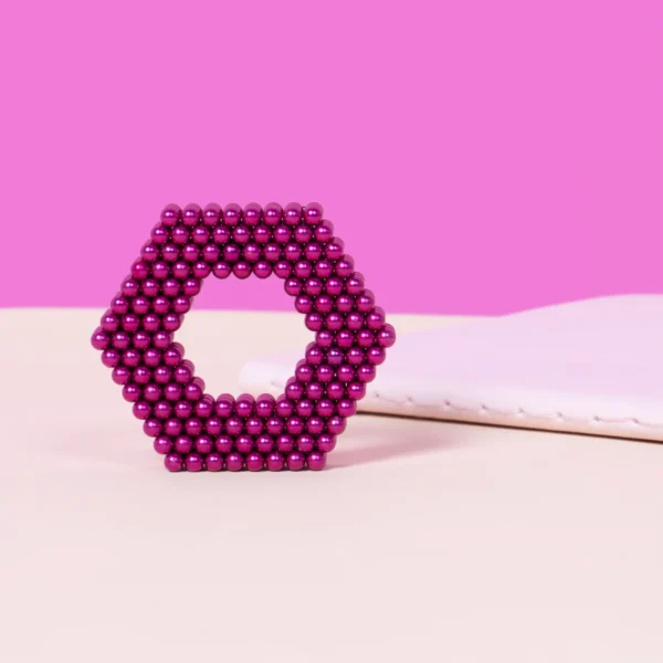 2. Glitzernde rosa Perlen in kreisförmiger Anordnung auf einem rosa Hintergrund, dekoratives Schmuckstück.